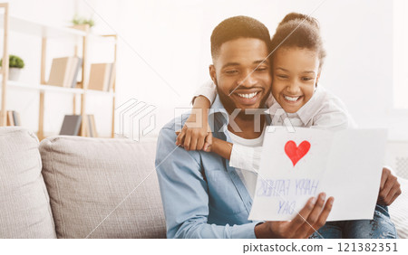 Happy father's day. Daughter congratulating dad and giving him postcard, free space Happy father's day. Daughter congratulating dad and giving him postcard, free space 121382351