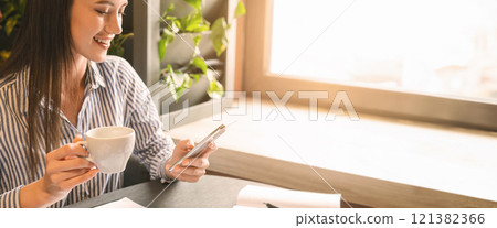 Coffee break in cafe. Millennial woman freelancer browsing on cellphone, working in cafeteria, empty space 121382366