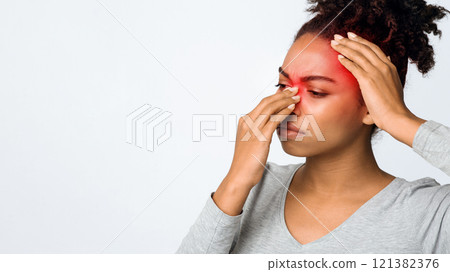 Exhausted afro woman rubbing nose and head, suffering from sinusitis, grey background, copy space 121382376