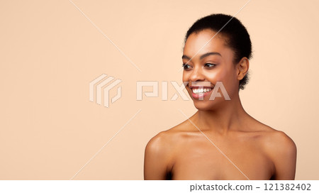 Happy African American Lady Looking Aside At Free Space Posing Shirtless Standing In Studio On Gray Background. Natural Female Beauty. Headshot Of Gorgeous Black Woman. Panorama 121382402