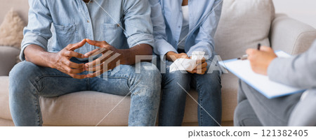 Marital Problems. Unrecognizable Afro Couple Listening To Relationship Coach's Advice Sitting On Sofa. Selective Focus, Cropped 121382405