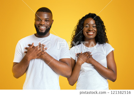 Thankful Black Couple Holding Their Palms Over Hearts, expressing gratitude, free space, panorama Thankful Black Couple Holding Their Palms Over Hearts, expressing gratitude, free space, panorama 121382516