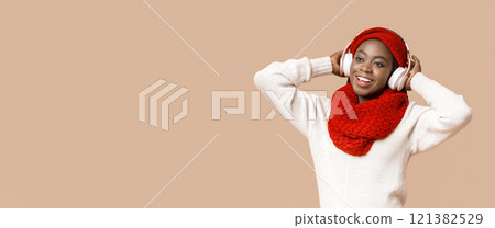 Dreamy african american winter woman with wireless headset looking at copy space, panorama 121382529