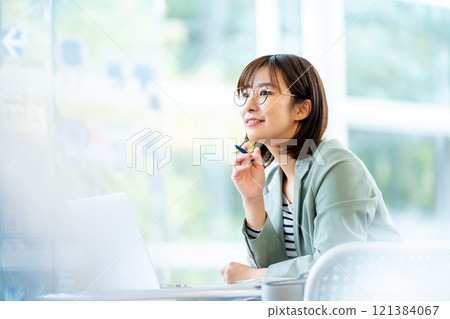 Woman working on a computer Woman working in a cafe 121384067