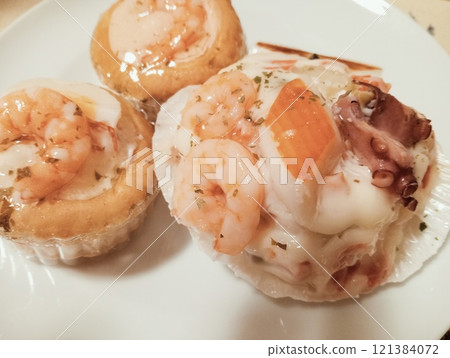 Seafood tartlets on a white plate, close-up Seafood tartlets on a white plate, close-up 121384072