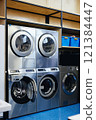 Vertical shot of professional washing machines with open drawers for detergents and softeners at self service laundry, copy space 121384447