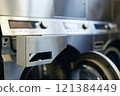 Close up on washing machine dispenser drawer for clothes softener and detergent in self service laundry, copy space 121384449
