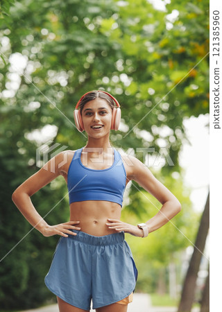 An Active Young Woman Enjoying a Refreshing Run in Lush Nature and Bright Sunshine An Active Young Woman Enjoying a Refreshing Run in Lush Nature and Bright Sunshine 121385960
