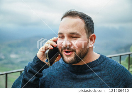 Man Smiles Brightly During Phone Call Man Smiles Brightly During Phone Call 121386410