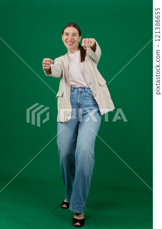 hold the steering wheel Young smiling happy positive cool woman she wears white top shirt casual clothes raise up hands dance have fun isolated on plain pastel hold the steering wheel Young smiling happy positive cool woman she wears white top shirt casual clothes raise up hands dance have fun isolated on plain pastel 121386655