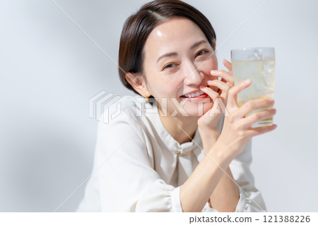 Woman drinking highball Woman drinking highball 121388226