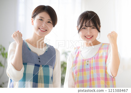Image of two nursery teachers looking at the camera with a fist pump - also good for changing jobs 121388467