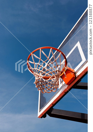 Red basketball hoop on a blue sky background Red basketball hoop on a blue sky background 121388877