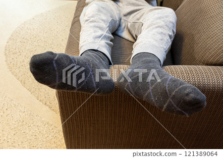 Lie down on the sofa and relax 121389064