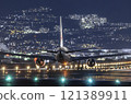 Night view of Itami Airport. A B767 about to take off. 121389911