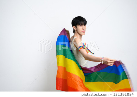 Portrait of young man holding rainbow flag... - Stock Photo [121391084 ...