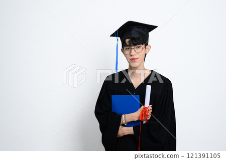 Proud graduate holding diploma standing on white background. Academic achievements concept 121391105
