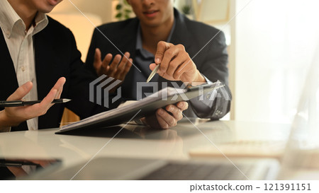 Cropped shot business advisor explaining the contract, offering it for the client to sign. Cropped shot business advisor explaining the contract, offering it for the client to sign. 121391151