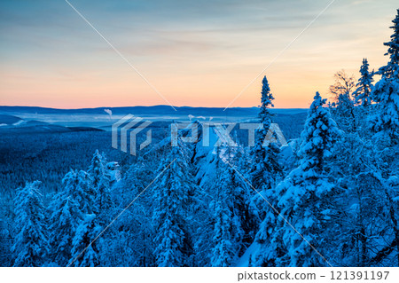 Rock, snow capped mountains and winter forest in the evening light Rock, snow capped mountains and winter forest in the evening light 121391197