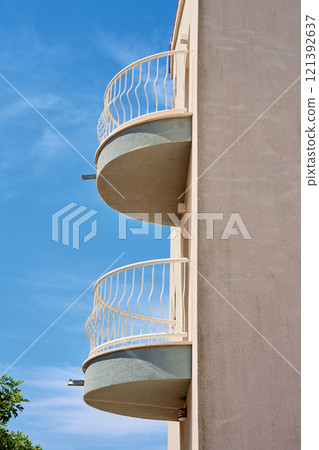 Minimalist Building with Circular Balconies Against Blue Sky 121392637
