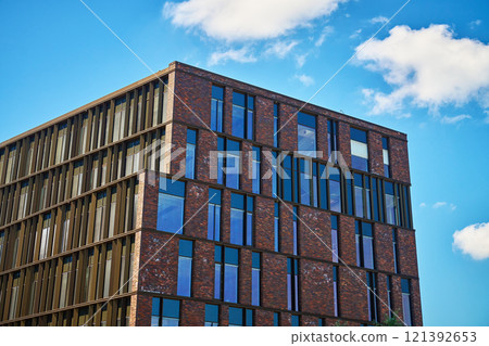 Office building exterior with brick facade and glass windows 121392653