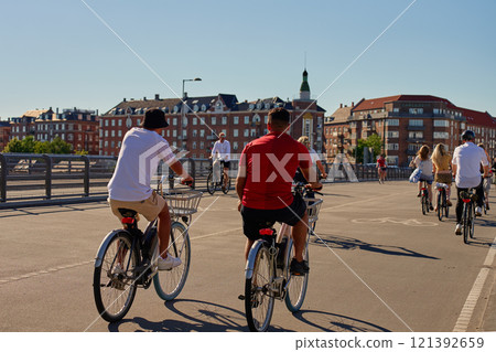 People riding bikes at city street in Copenhagen, Denmark People riding bikes at city street in Copenhagen, Denmark 121392659