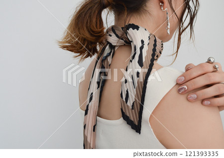 Hands of a woman wearing a scarf 121393335