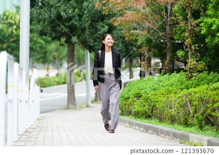 走在人行道上的中年女商人 121393670