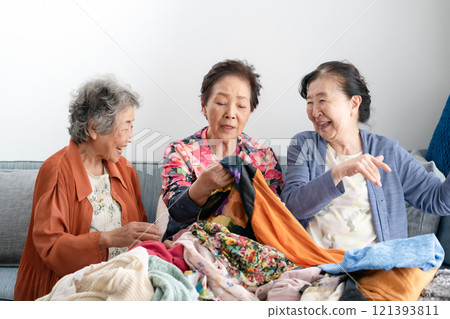 Senior woman choosing clothes, decluttering Senior woman choosing clothes, decluttering 121393811