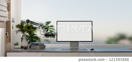 A modern, simple office workspace featuring a computer with a white desktop mockup and a microphone. A modern, simple office workspace featuring a computer with a white desktop mockup and a microphone. 121393888
