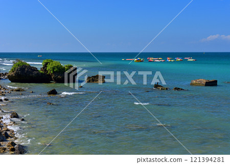 Natural scenery of rocks and waves on the coast and recreational airboat 121394281
