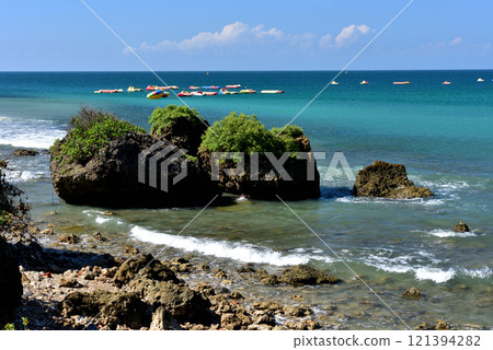 Natural scenery of rocks and waves on the coast and recreational airboat 121394282