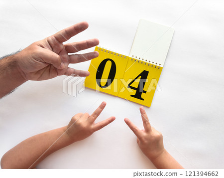 Counting hands with calendar on a white background celebrating number four Counting hands with calendar on a white background celebrating number four 121394662