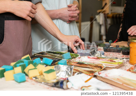 Art workshop scene with young caucasian adults engaging in creative activities Art workshop scene with young caucasian adults engaging in creative activities 121395438