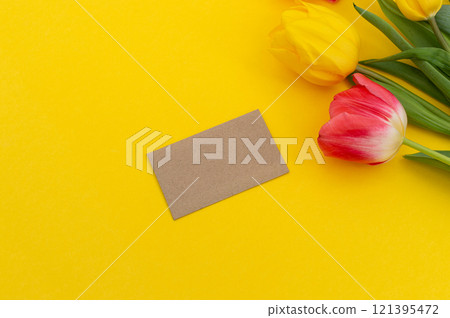 Spring Tulips with Blank Card on Yellow Background Spring Tulips with Blank Card on Yellow Background 121395472