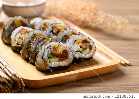 Gimbap or kimbap, Korean food made from cooked rice with vegetables wrapped with dried seaweed 121395515