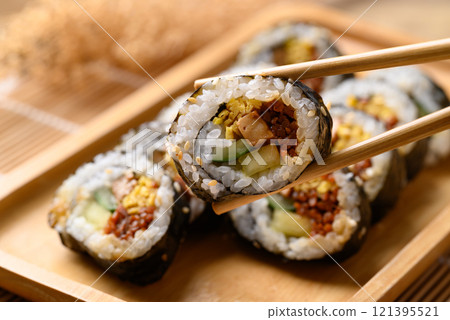 Gimbap or kimbap, Korean food made from cooked rice with vegetables wrapped with dried seaweed 121395521