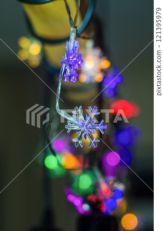 Colorful Snowflake LED Lights Creating a Festive Glow at Night. High quality photo Colorful Snowflake LED Lights Creating a Festive Glow at Night. High quality photo 121395979