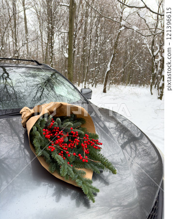 Evergreen Bouquet on Car in Snowy Forest 121396615