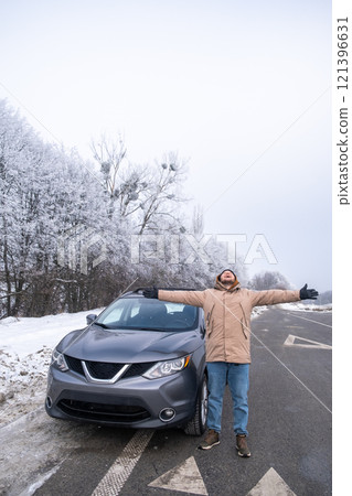 Person with SUV on Snowy Road in Winter Landscape 121396631