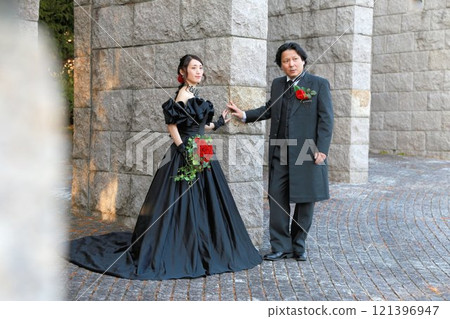 Bride and groom in black wedding dresses Bride and groom in black wedding dresses 121396947
