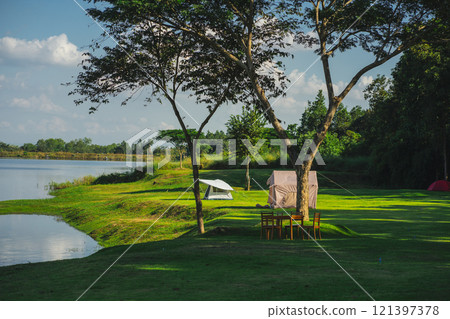 travel and people activity concept with camping on grass  with mountain and lake on foreground 121397378