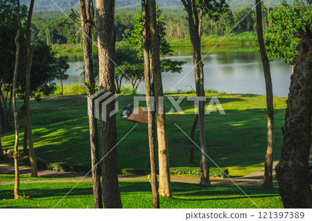 travel and people activity concept with camping on grass with mountain and lake on foreground travel and people activity concept with camping on grass with mountain and lake on foreground 121397389