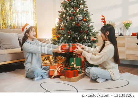 Two friends decorated Christmas tree at home. Two friends decorated Christmas tree at home. 121398262