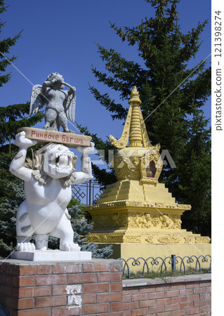 A statue of a Buddhist deity and stupa at Rinpoche Bagsha datsan. Inscription: 'Rinpoche Bagsha' A statue of a Buddhist deity and stupa at Rinpoche Bagsha datsan. Inscription: 'Rinpoche Bagsha' 121398274