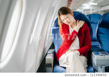 Photo of a frustrated woman sitting on an airplane with her head in her hands. Asian woman sitting Photo of a frustrated woman sitting on an airplane with her head in her hands. Asian woman sitting 121398650
