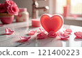 Heart-shaped pink soap with petals in romantic setting 121400223