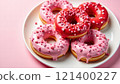 Heart-shaped donuts with pink and red glaze on a plate 121400227