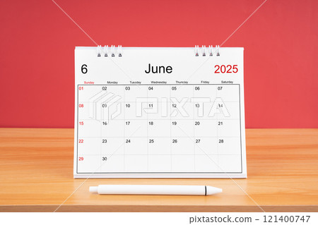 June monthly desk calendar for 2025 year and pen on the wooden table. 121400747