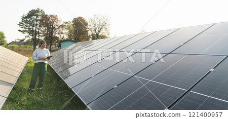 Female farmer with digital tablet on a modern farm using solar panels. Female farmer with digital tablet on a modern farm using solar panels. 121400957